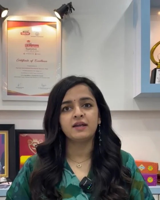 Shraddha Bhat in her office at Jigyaasa, with the school's Certificate of Excellence and a trophy behind her